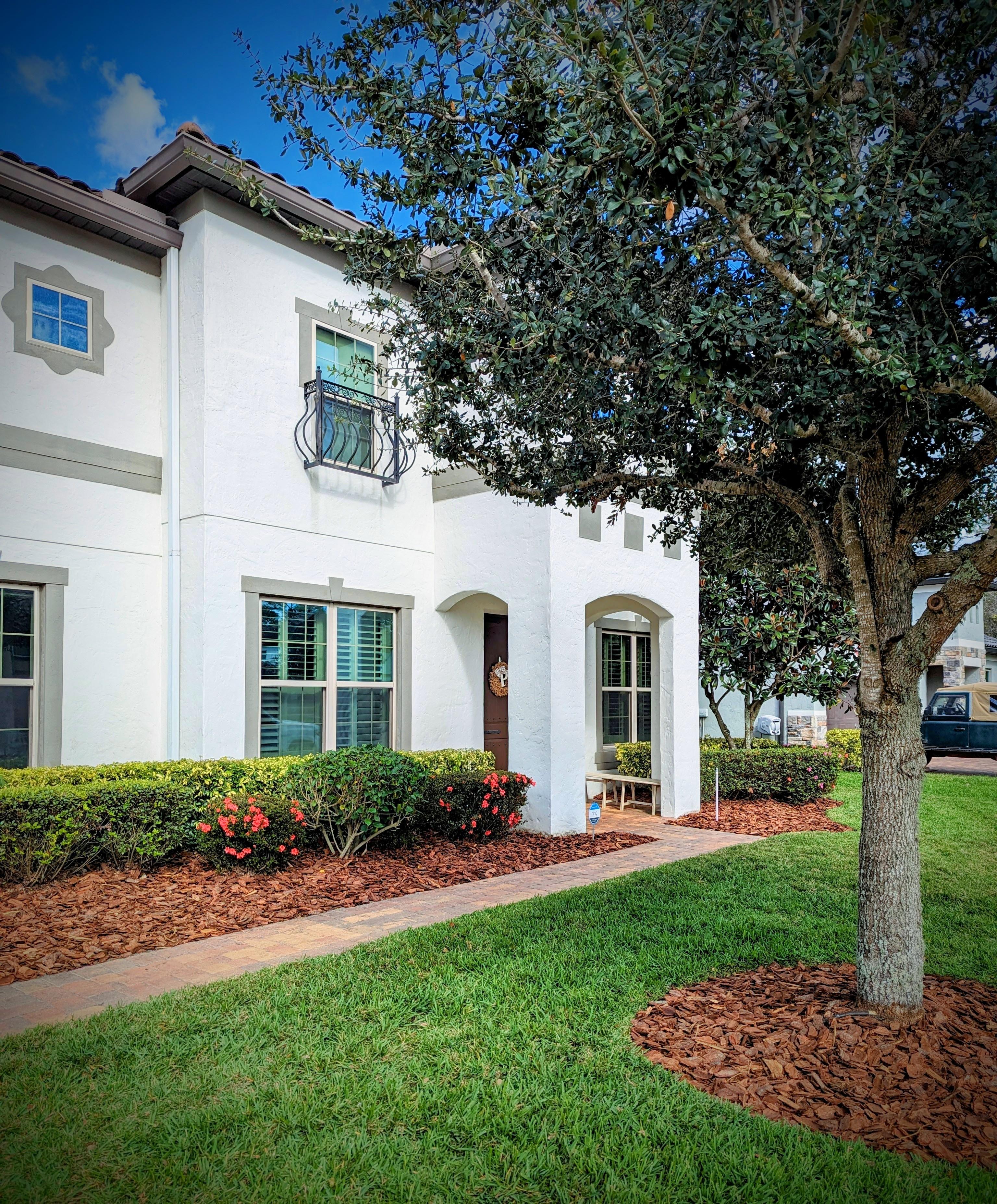 Fresh mulch beds and vibrant landscape maintenance at a home in Oviedo, Florida by Freedom Lawn Pros